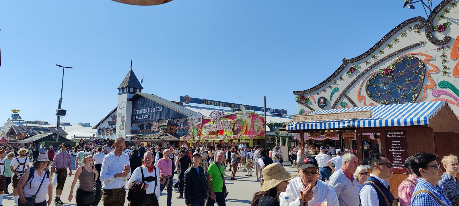Dense opening-Saturday crowd on the Oktoberfest main street under a blue sky