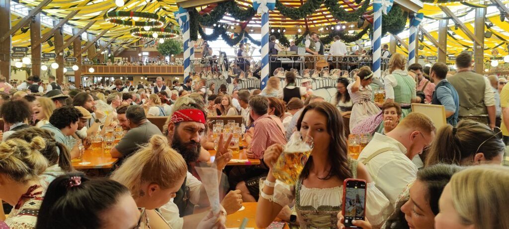 Packed tables under the yellow ceiling of a beer tent on opening Saturday at Oktoberfest