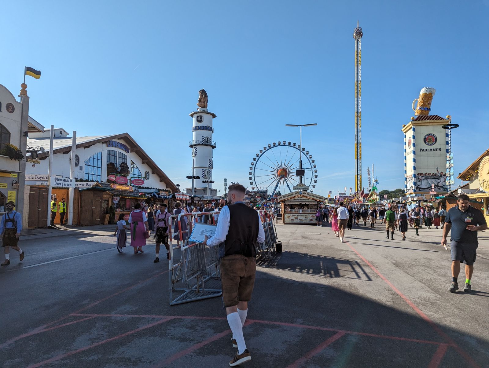 Quiet Oktoberfest main avenue in the morning with the Ferris wheel and tent towers