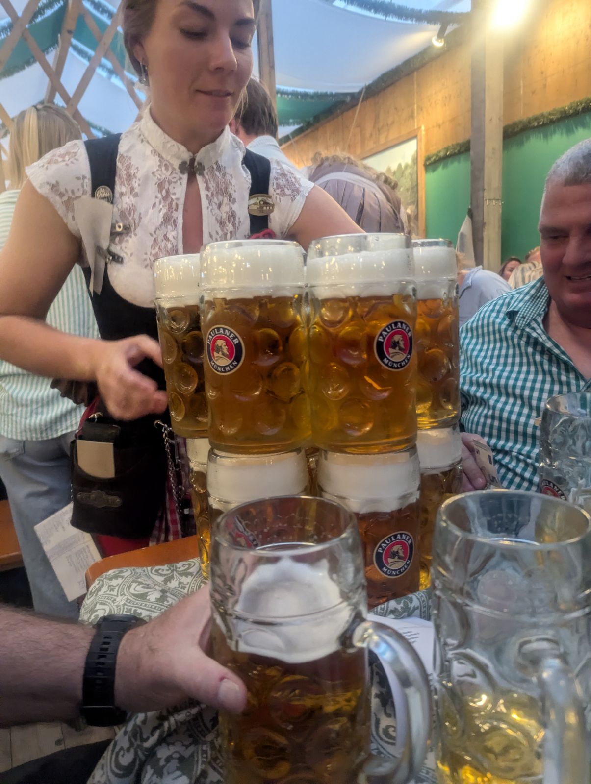 A waitress carrying eight full Maß at once through a beer tent