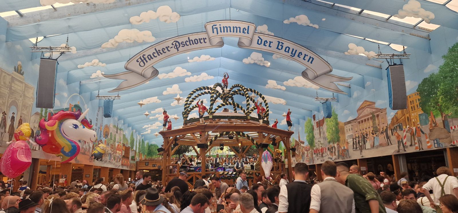 Hacker-Festzelt interior with the Himmel der Bayern painted-sky ceiling above a packed hall